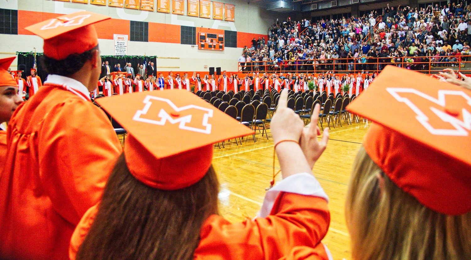 The newly-minted Mineola alumni sing their alma mater together as a class one last time. [more moments of Mineola grads]